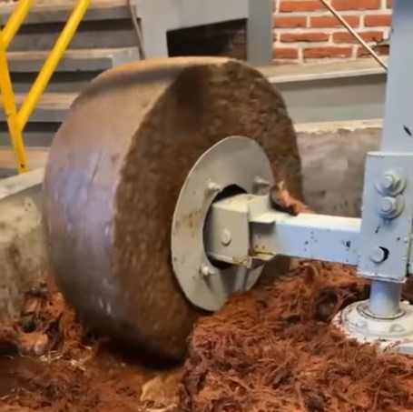 Tahona stone wheel mid-grind at the Arandas distillery